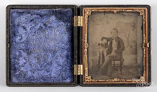 Ambrotype image of a young man and his camera, 19th c., sixth plate, in a Union case.