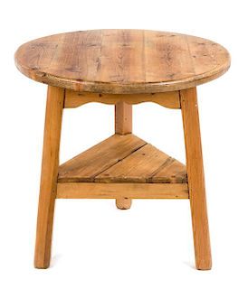An English Stripped Pine Cricket Table Height 30 x diameter 29 1/2 inches.