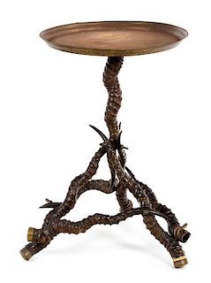 A Victorian Antler and Brass Table Height 23 1/2 x diameter 15 1/2 inches.