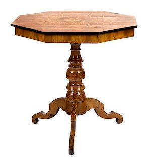An Italian Walnut and Marquetry Center Table Height 28 1/2 x diameter 29 inches.
