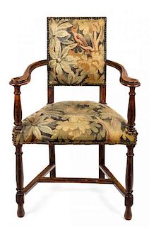 A Baroque Style Stained Fruitwood and Tapestry Upholstered Armchair Height 36 inches.