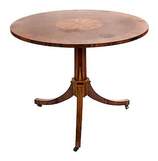 A Louis XVI Style Tulipwood and Parquetry Circular Occasional Table Height 28 1/4 x diameter 19 1/2 inches.