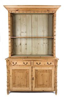 A Regency Style Stained Pine and Bamboo Bookcase Height 87 x width 51 x depth 25 inches.