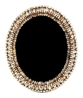 A Shell Encrusted Oval Mirror Height 24 inches.