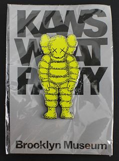 KAWS (American, b.1974) "What Party?" yellow small pin, brand new, 2 3/4 x 1 1/4 in.