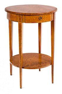 A Walnut-Veneered Occasional Table Height 29 x diameter 20 inches.