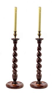 A Pair of Carved Oak Candlesticks