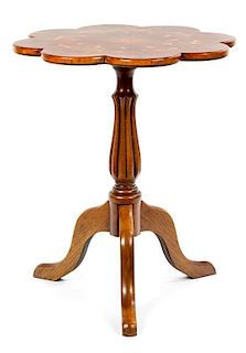 An English Mahogany and Oyster-Veneered Occasional Table Height 26 3/4 x diameter 22 1/4 inches.