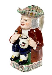A Staffordshire Figural Ewer Height 9 3/4 inches.