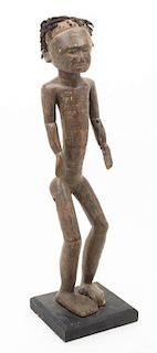 * A Carved Ethnographic Figure Height 23 inches.