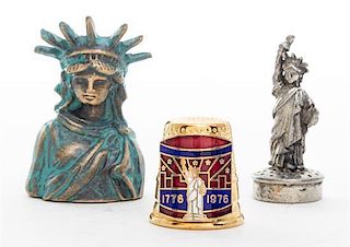 A Group of Three Metal Statue of Liberty Thimbles Height of tallest 1 1/2 inches.