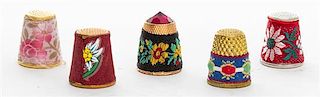 A Collection of Five Fabric Covered Metal Thimbles Height of tallest 3/4 inch.