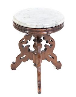 * A Victorian Walnut Occasional Table Height 19 x diameter 14 1/2 inches.