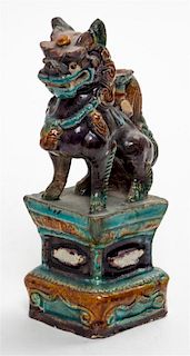 A Polychrome Enamel Porcelain Figure of a Fu Lion. Height 7 inches.