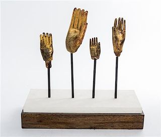 A Group of Four Southeast Asian Giltwood Hands of Buddha Width of stand 15 inches.