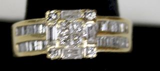 14k y.g. ladies ring having 8 small square cut diamonds and 4 baguette cut diamond. Each side has 2