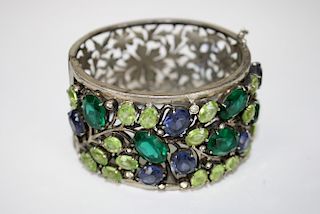 Fine costume bangle having floral openwork back and jeweled floral front. 1½" wide.