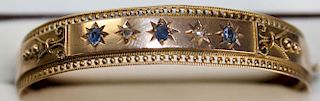 Victorian 10k yellow gold bangle having 2 old mm cut rd diamonds and 3 rd cut sapphires in star sett