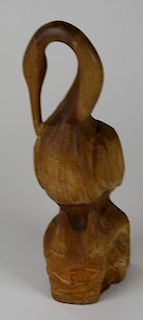 NW Coast/ Inuit carving of a pelican sitting on a man's head, owl, eye, ht 17”