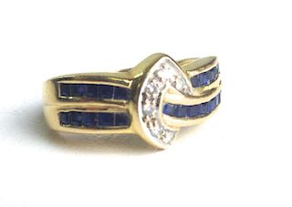 18k y.g. ladies ring with 26 channel set emerald cut sapphires and 6 .02ct rd cut diamonds. Size 7½.