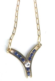 18k y.g. chain and pendant having V form with 8 .04 ct square cut sapphires and one .1ct round cut d