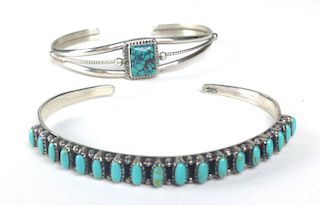Two Navajo sterling and turquoise bangles, one signed J. Regay.