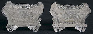 pr of early pressed glass master salts with basket of flowers decoration, both damaged, length 3”