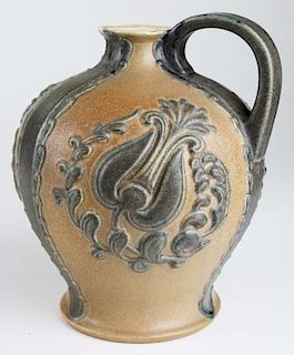 Harthey majollica type high relief pitcher with ground base # 518, ht 8.5”