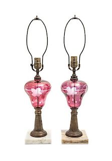 A Pair of Cranberry Cut-to-Clear and Brass Lamps, Height 24 1/4 inches.