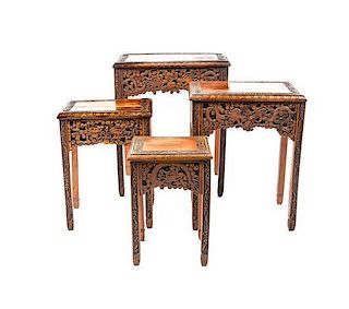 A Set of Four Carved Nesting Tables, Height of tallest 24 1/2 inches.