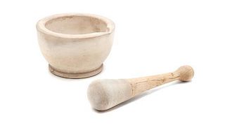 A Stone Mortar and Pestle, Height of mortar 3 3/8 x diameter 5 5/8 inches.