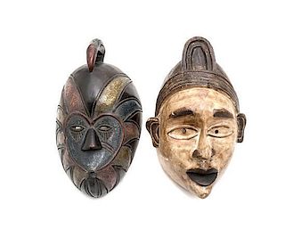 A Pair of African Style Carved and Painted Wooden Masks, Height of taller 15 1/2 inches.