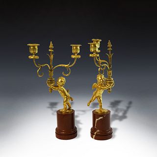 Pair of French XIX century bronze candelabras with two putti.