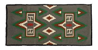 A Navajo Germantown Weaving, 34 x 69 inches.