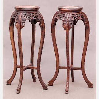 A Pair of Chinese Carved Hardwood Stands with Marble Inset Tops, 20th Century.