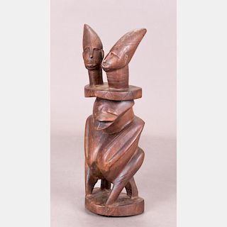 An African Carved Hardwood Metamorphic Figure, 20th Century.