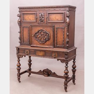 A Renaissance Revival Carved Oak and Walnut Cabinet, 20th Century.