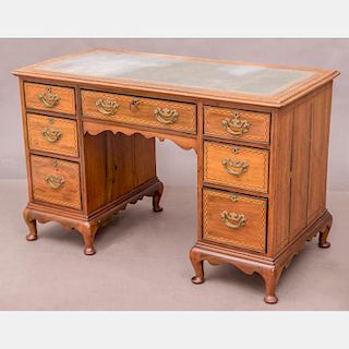 A Georgian Style Mahogany Kneehole Desk by Maple and Co., 20th Century.