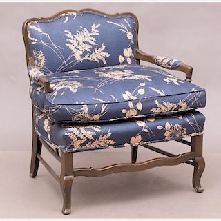 A French Provincial Style Stained Hardwood and Upholstered Armchair, 20th Century.