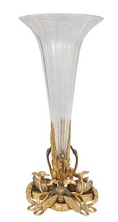 Gilt Bronze and Crystal Trumpet Vase, c. 1880, the fluted clear vase supported by three large leaves, on a base with three swans, relief flowers, and 