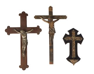 Group of Three Wall Crucifixes, consisting of a white metal example on a wooden coptic cross, 20th c., a gilt metal example with a holy water font, 20