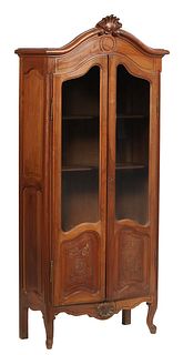 French Louis XV Style Carved Beech Vitrine, early 20th c., the arched top with a shell form crest over double arched doors with glazed upper panels ab