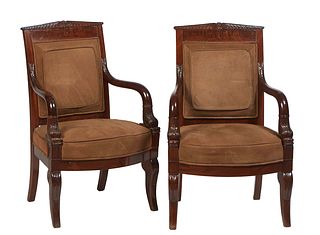 Pair of French Empire Style Carved Mahogany Fauteuils, 19th c., the canted peaked crest over an upholstered back flanked by curved dolphin arms, to a 