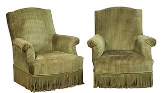 Pair of French Carved Walnut Bergeres, 20th c., the arched canted back over rolled arms and a bowed seat, on cylindrical legs, in green cord upholster