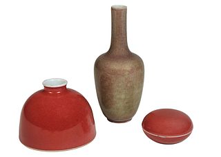 Group of Three Chinese Peach Bloom Porcelain Scholar Items, 20th c., consisting of a covered paste box, a circular water pot; and a small baluster vas