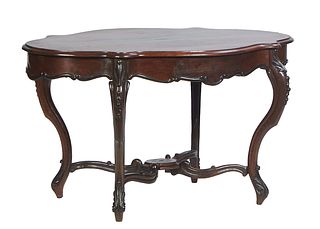 French Rosewood Grained Carved Walnut Center Table, c. 1870, the rounded edge tortoise top over a wide scalloped skirt with a frieze drawer on the two