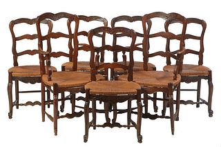Set of Seven French Provincial Louis XV Style French Carved Oak Rushseat Dining Chairs, consisting of a pair of armchairs and five side chairs, with a
