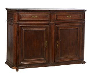 French Provincial Carved Oak Louis XIV Style Sideboard, 19th c., the canted corner three board top over two frieze drawers above double cupboard doors