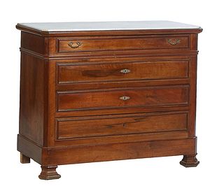 French Carved Walnut Marble Top Commode, 19th c., the inset figured white canted corner top over a frieze drawer and three lower drawers, on ogee bloc