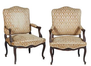 Pair of French Louis XV Style Carved Walnut Fauteuils, 20th c., the arched upholstered back to upholstered arms over a bowed seat, on cabriole legs, i